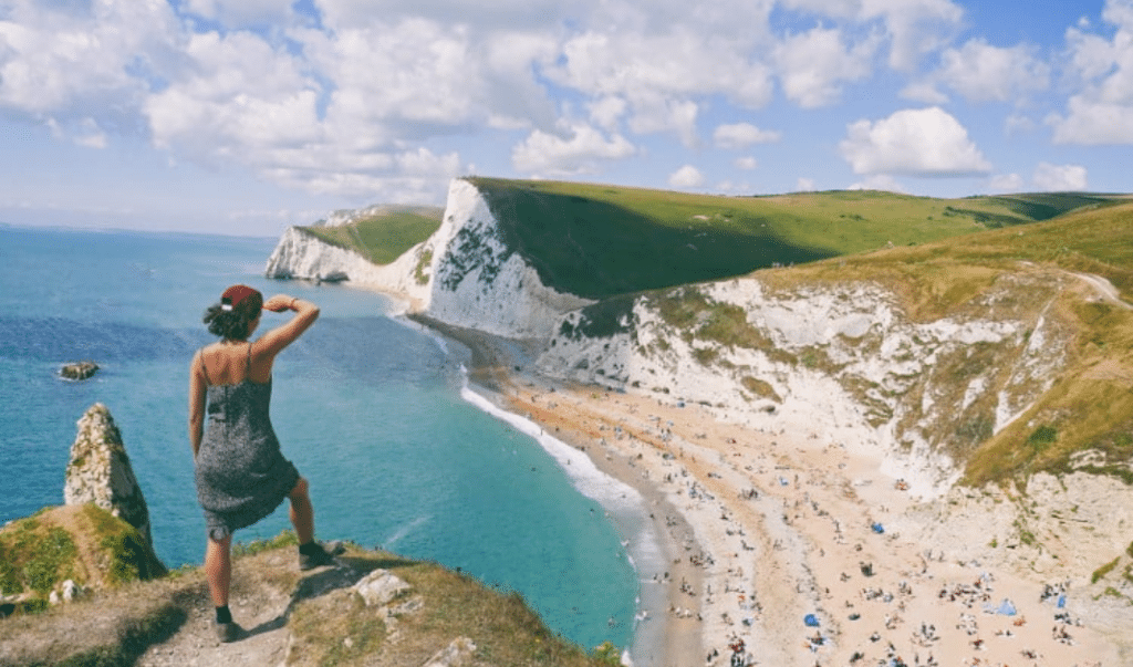 A woman looking out at a beach over remarkable learning and development innovations in Dorset.